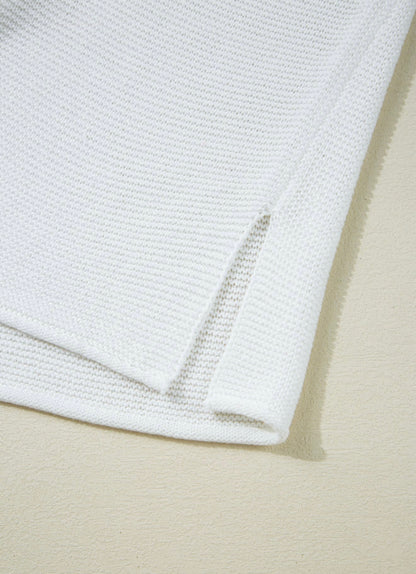 White sleeveless sweater with side splits