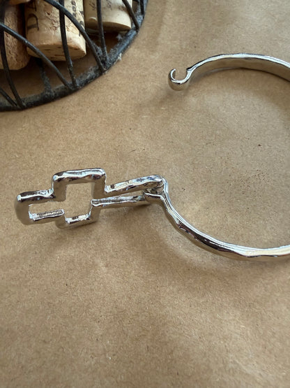 Ivy's Gifts & Boutique J25 Cross bangle bracelet with flexible spring design for comfortable wear and stylish accessory.