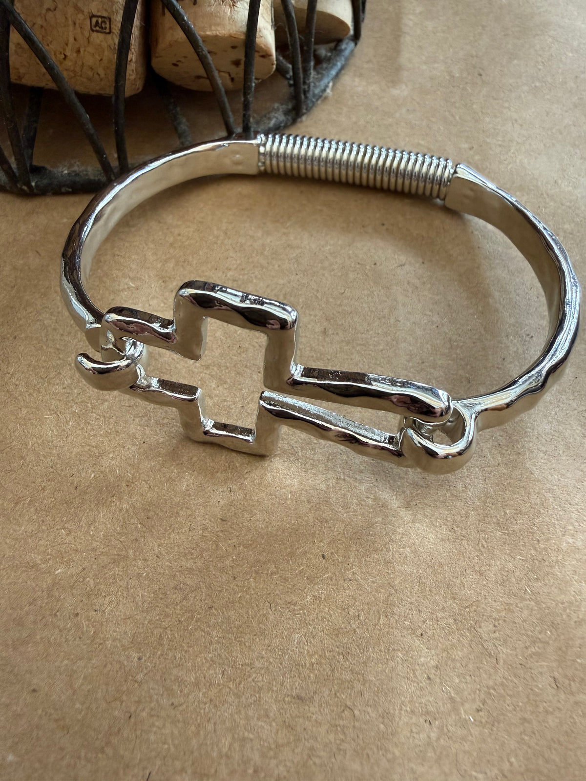 Silver J25 Cross Bangle Bracelet by Ivy's Gifts & Boutique featuring a flexible spring design for comfortable wear.