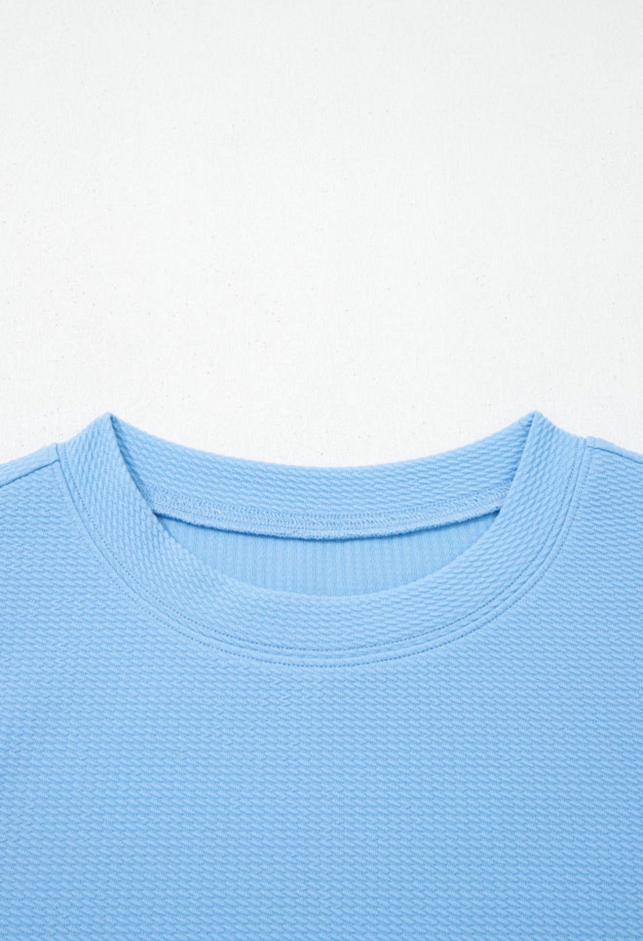Light blue floral puff sleeve top by Ivy's Gifts & Boutique featuring a stylish and feminine design.