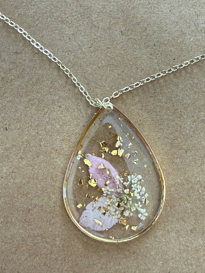 Dried flower pendant necklace by Ivy's Gifts & Boutique featuring a delicate floral charm on a silver chain.