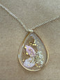 Dried flower pendant necklace by Ivy's Gifts & Boutique featuring a delicate floral charm on a silver chain.