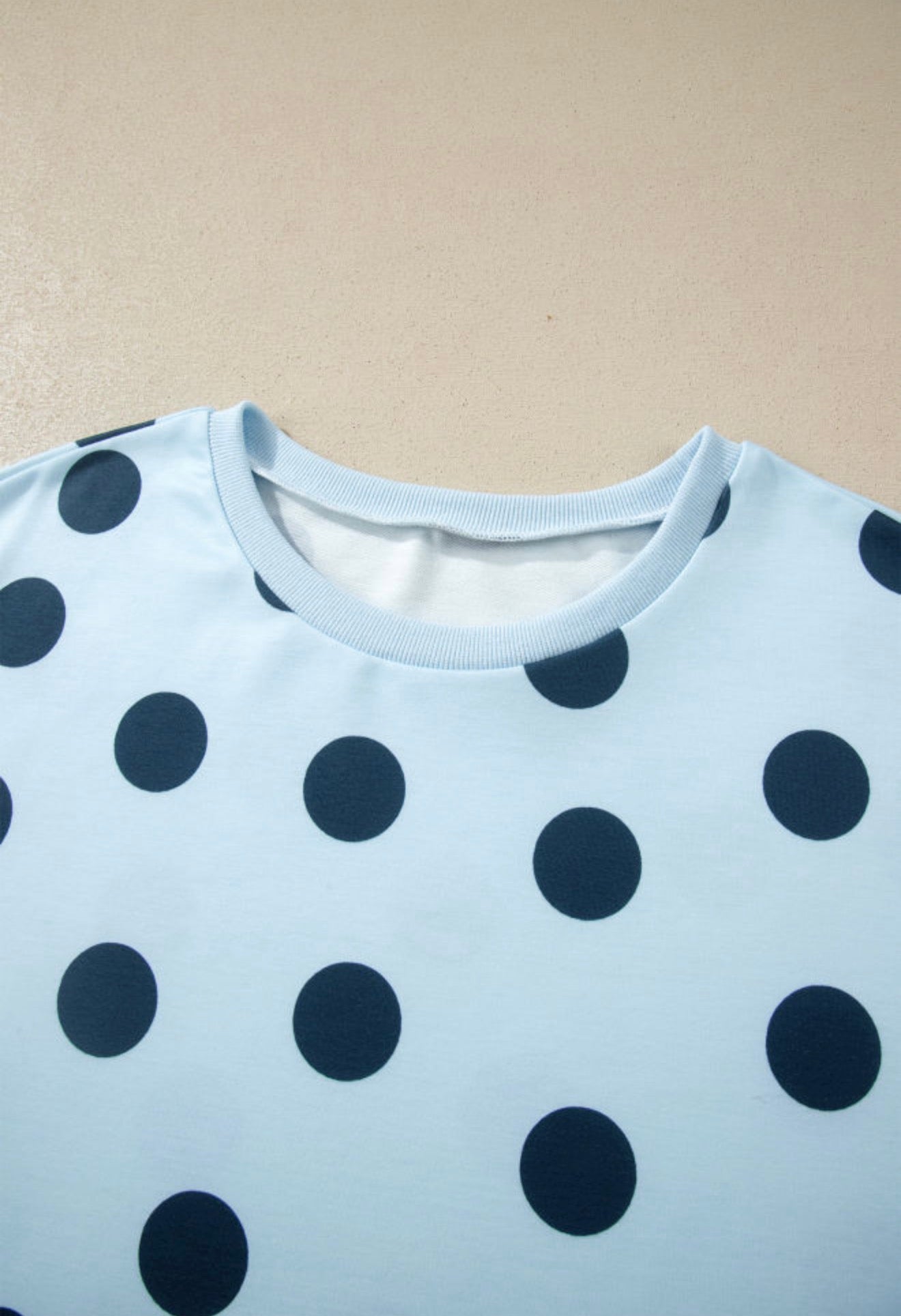 Light blue polka dot 2-piece short set for kids by Ivy's Gifts & Boutique, featuring a short-sleeve top and matching shorts.