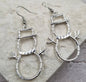 Silver snowman silhouette earrings from Ivy's Gifts & Boutique featuring festive winter design.