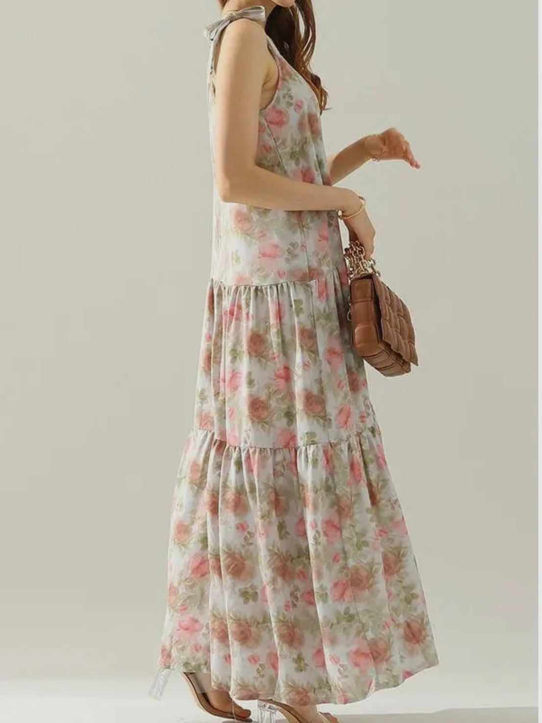 A floral maxi dress with shoulder straps from Ivy's Gifts & Boutique, featuring a colorful tie-dye pattern and flowing silhouette.