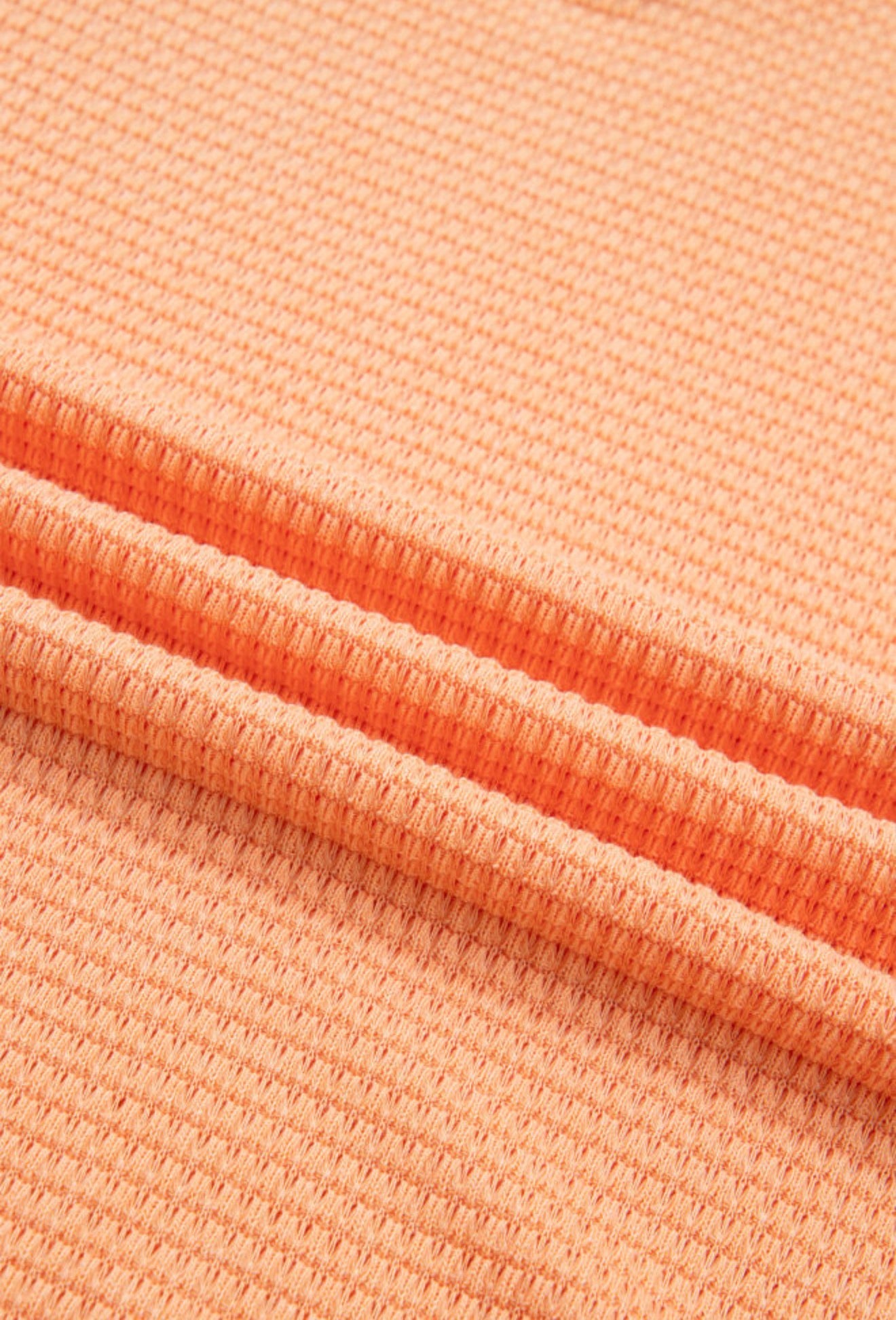 Orange waffle weave short sleeve V-neck top from Ivy's Gifts & Boutique featuring a casual, comfortable design.