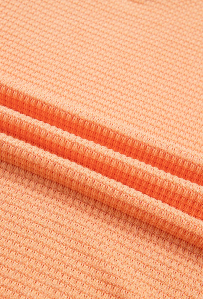 Orange waffle weave short sleeve V-neck top from Ivy's Gifts & Boutique featuring a casual, comfortable design.