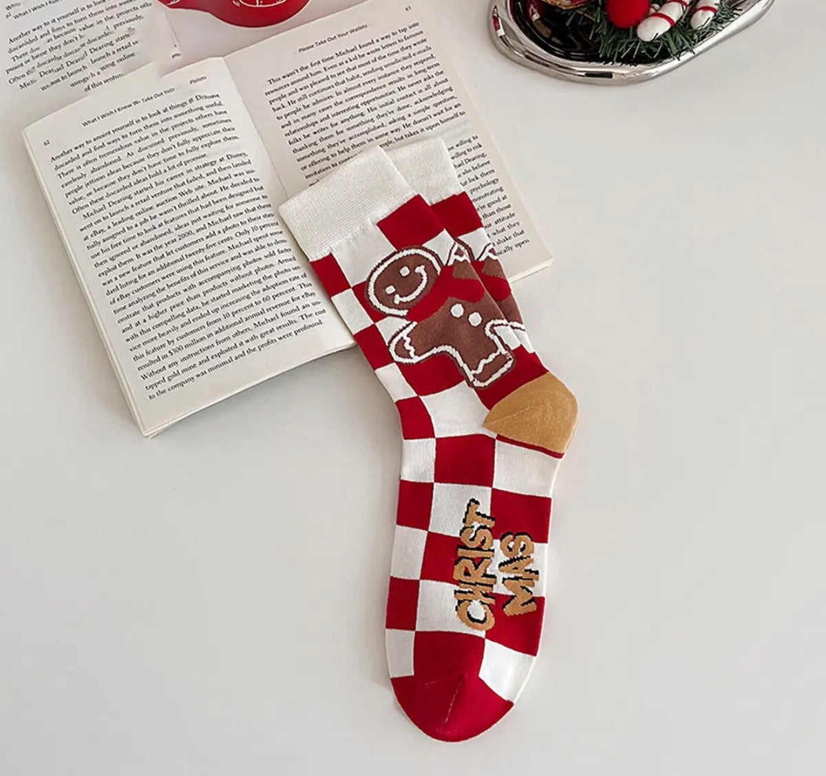 Ivy's Gifts & Boutique gingerbread checkerboard holiday socks featuring festive gingerbread men and red and green pattern.