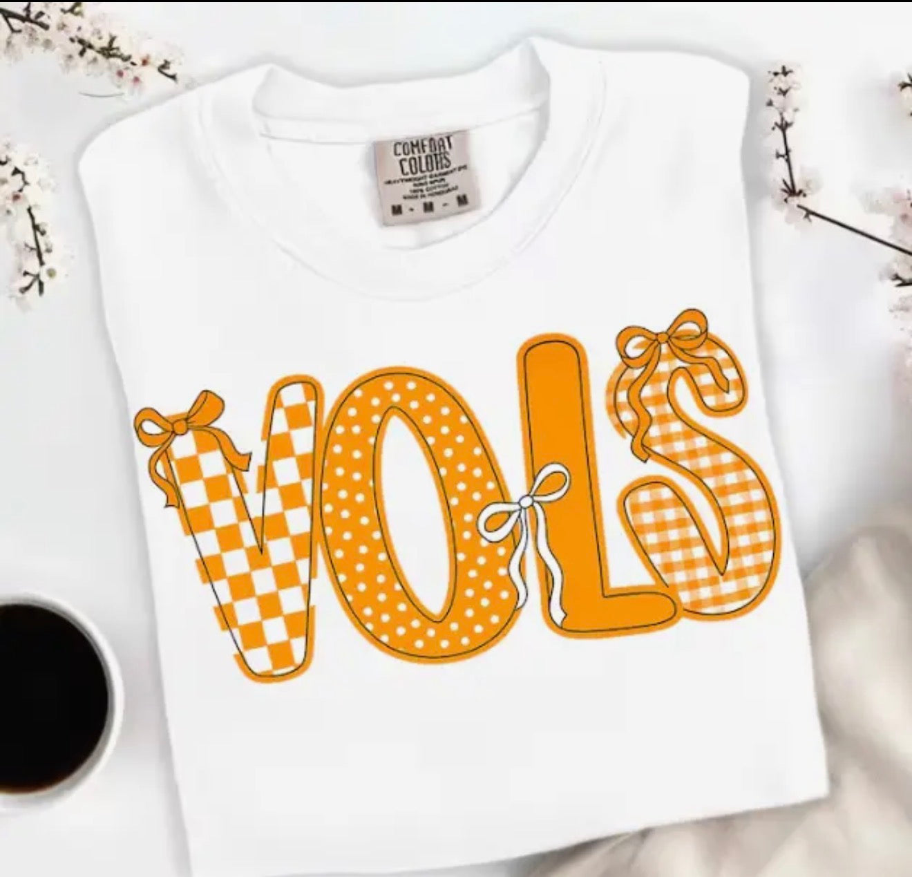 Ivy's Gifts & Boutique TN12 VOLS T-shirt with bow accents, white casual top with decorative bow details on the front.