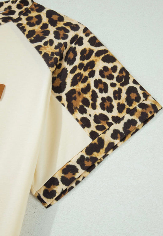 Animal print trimmed short sleeve button neckline top by Ivy's Gifts & Boutique, featuring a stylish animal print design.