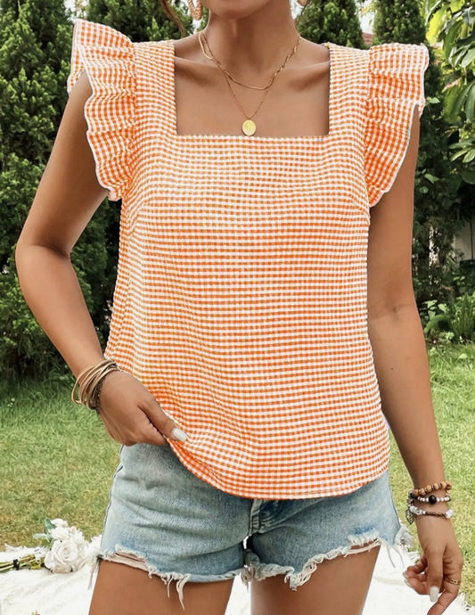 Orange and white checked square neckline top with butterfly cap sleeves from Ivy's Gifts & Boutique.