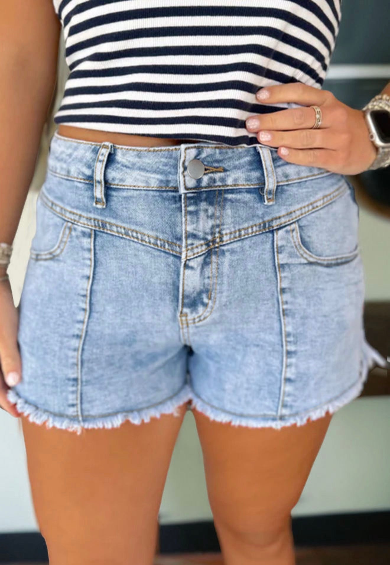 Blue jean shorts with frayed hem from Ivy's Gifts & Boutique, featuring classic denim styling and distressed edges.