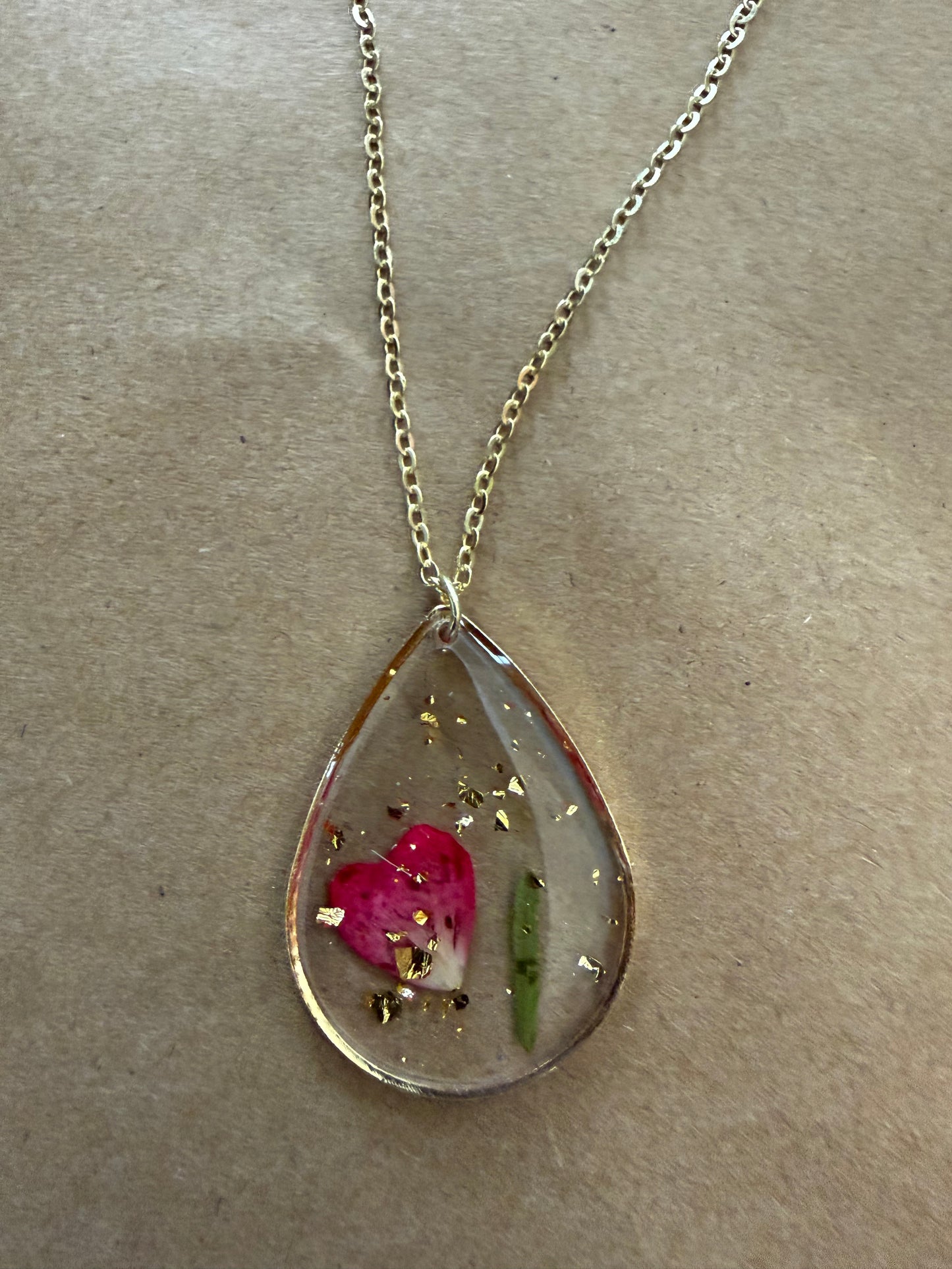 Dried flower pendant necklace from Ivy's Gifts & Boutique featuring a delicate floral charm on a silver chain.