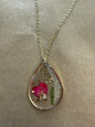 Dried flower pendant necklace from Ivy's Gifts & Boutique featuring a delicate floral charm on a silver chain.