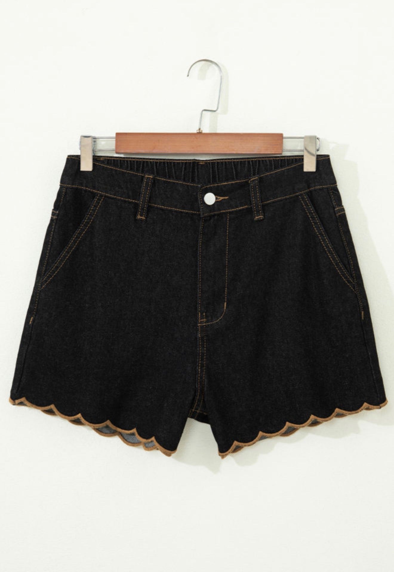 Black stretch denim scallop hem shorts by Ivy's Gifts & Boutique, featuring a stylish scalloped edge and fitted design.