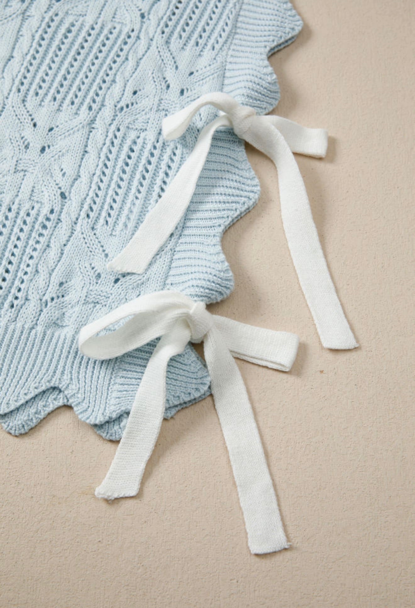 Light blue summer sweater with side tie accents, by Ivy's Gifts & Boutique, featuring a relaxed fit and casual style.