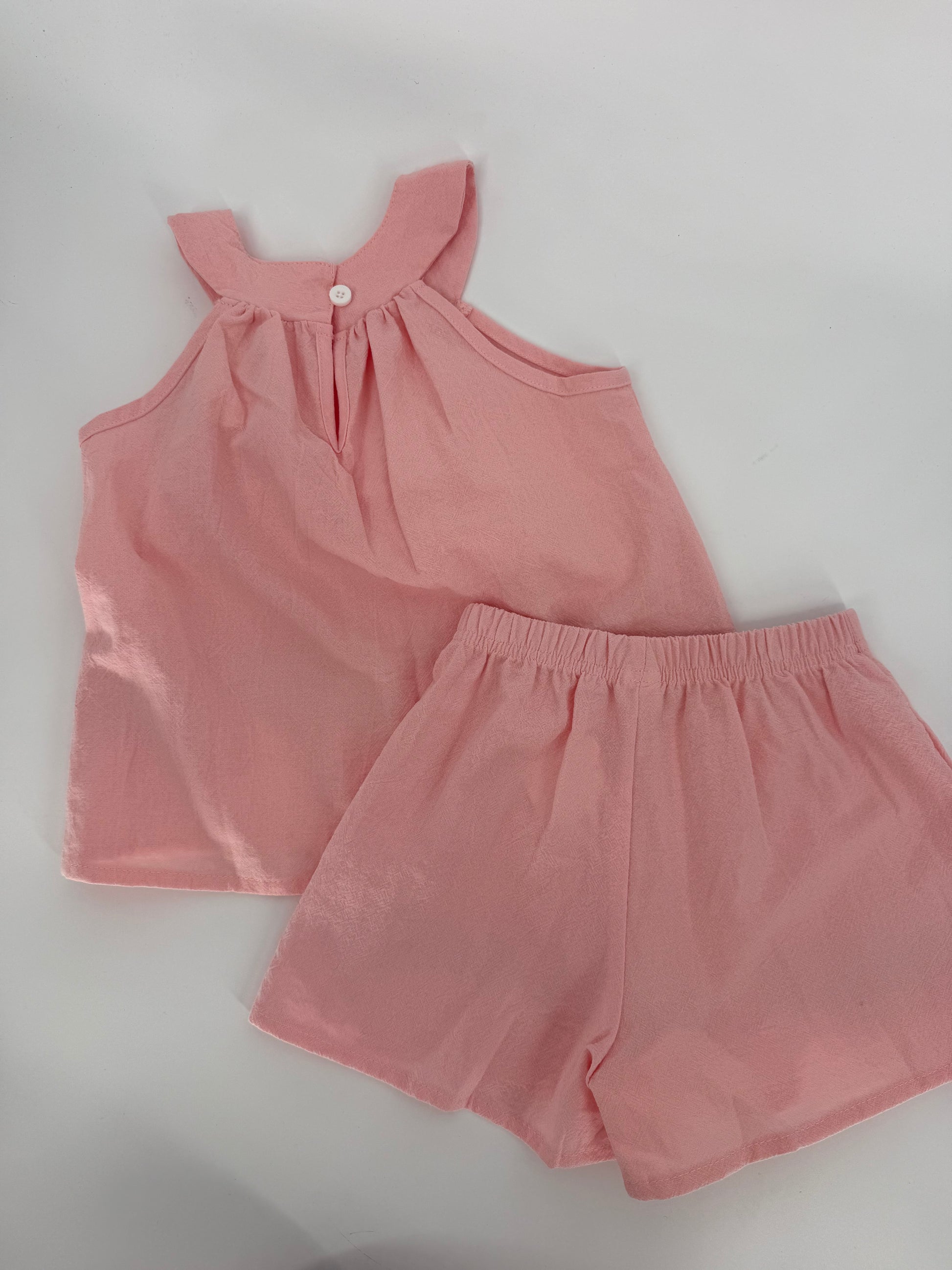 Pink crinkle fabric two-piece short set with red floral accents from Ivy's Gifts & Boutique, featuring a stylish, casual summer look.