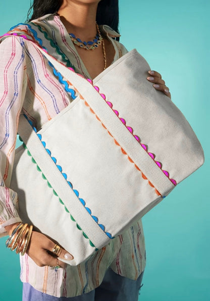 White tote bag with colorful ricrac trim from Ivy's Gifts & Boutique, showcasing its spacious design and vibrant decorative details.