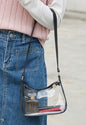 Clear ML57 purse with black strap and gold zipper, showcasing a stylish transparent bag by Ivy's Gifts & Boutique.