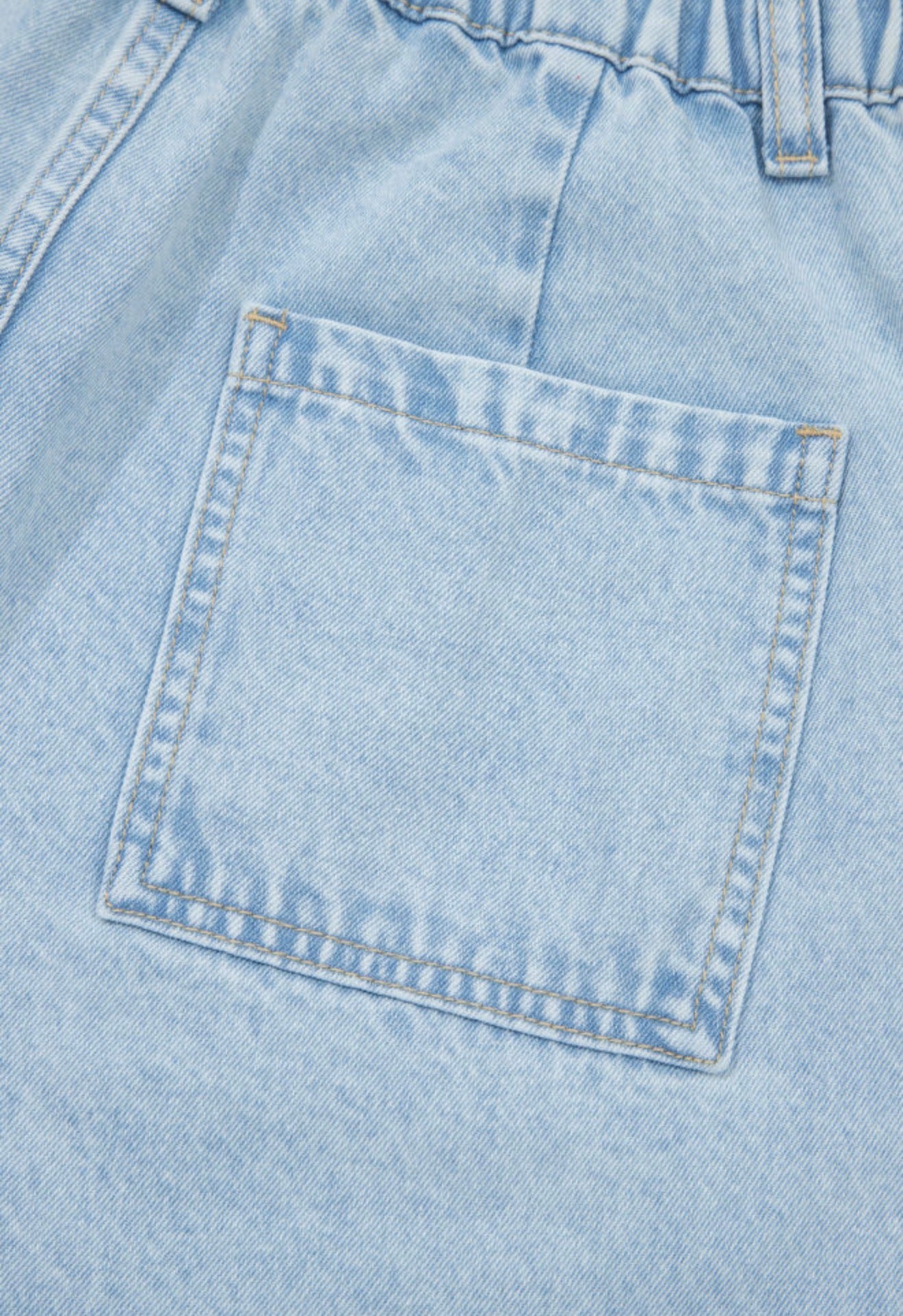 Light wash wide-leg jeans with frayed hems, side splits, and studded accents from Ivy's Gifts & Boutique.
