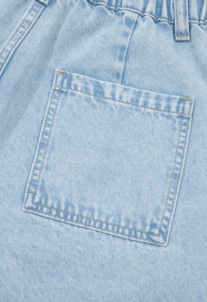 Light wash wide-leg jeans with frayed hems, side splits, and studded accents from Ivy's Gifts & Boutique.