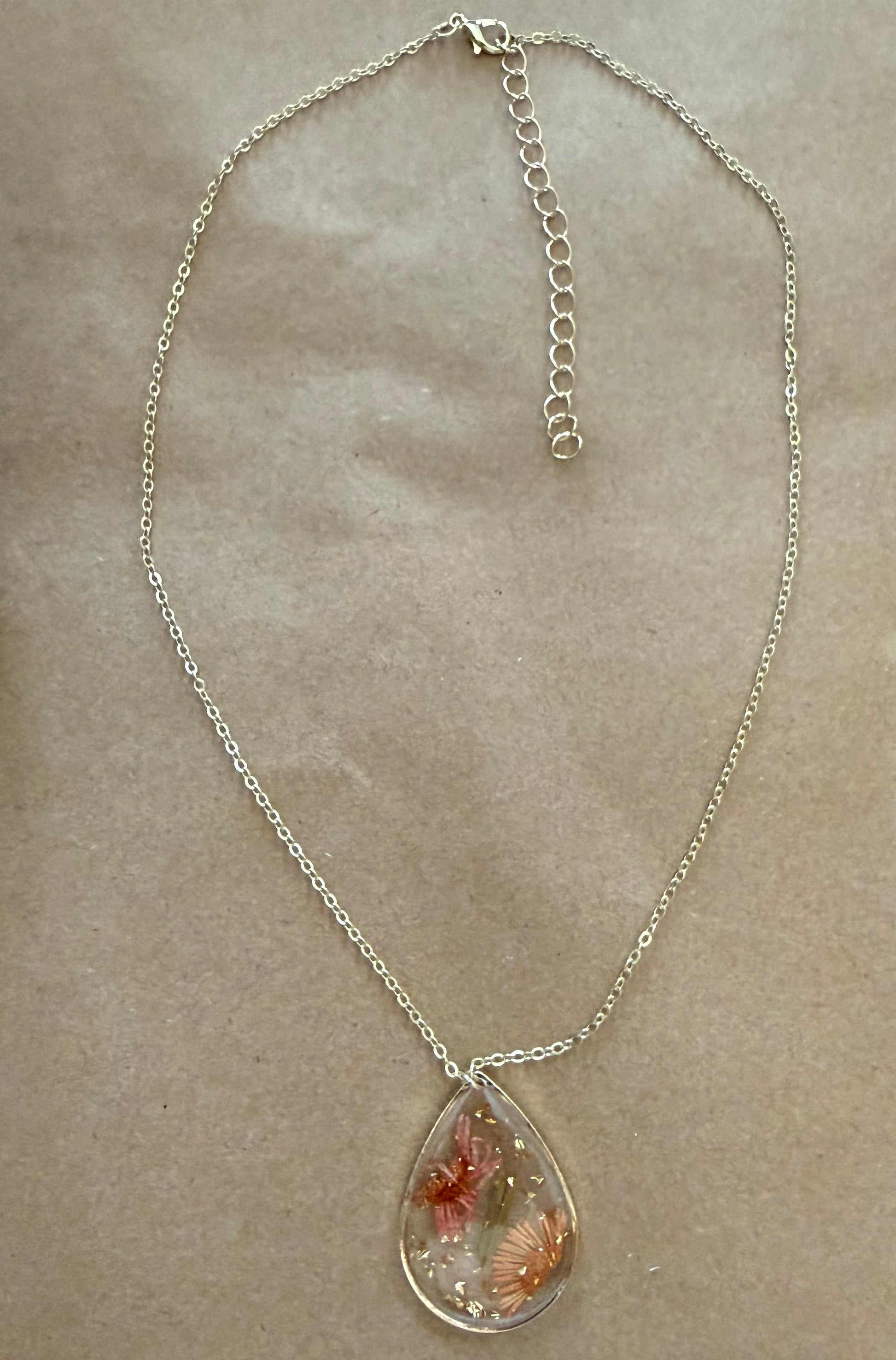 Dried flower pendant necklace from Ivy's Gifts & Boutique featuring a delicate floral design on a silver chain