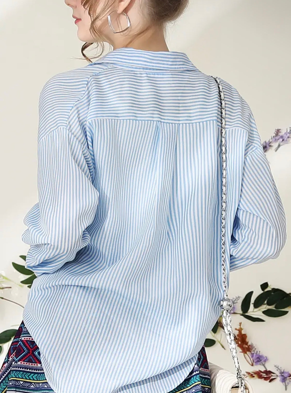 Blue striped button-up blouse by Ivy's Gifts & Boutique, styled with a classic collar and versatile design.