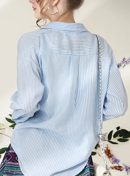 Blue striped button-up blouse by Ivy's Gifts & Boutique, styled with a classic collar and versatile design.