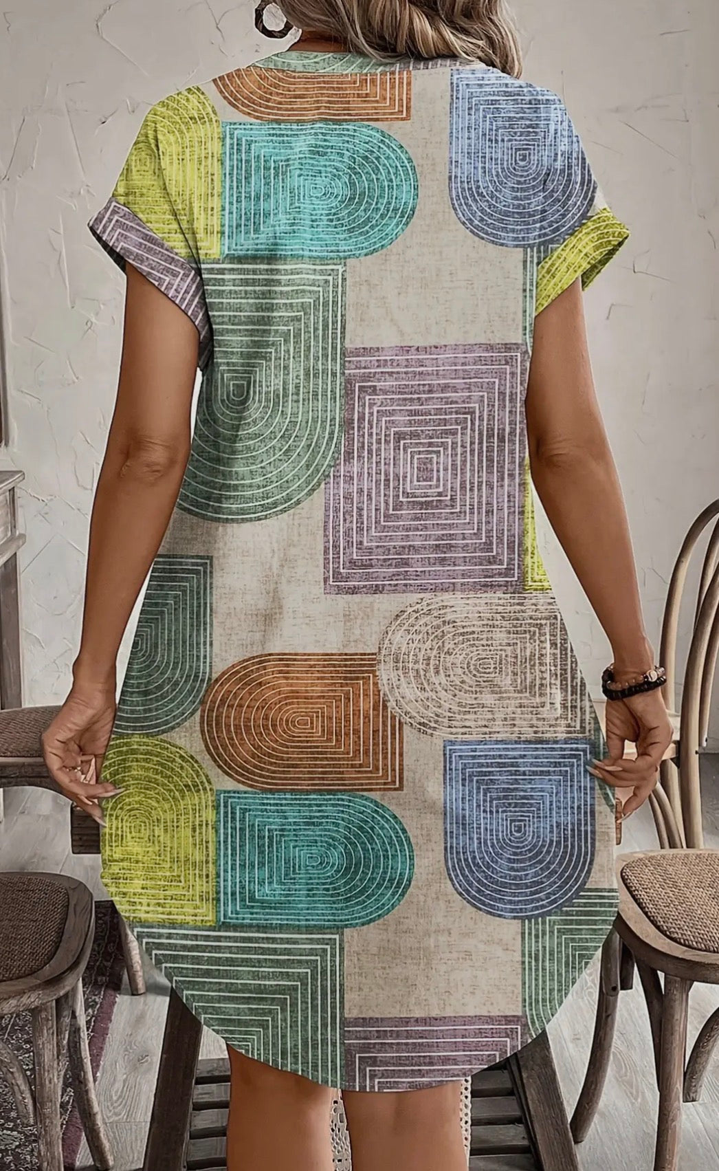 Abstract print button-front dress from Ivy's Gifts & Boutique, featuring a stylish A130 design with vibrant colors and a fitted silhouette.