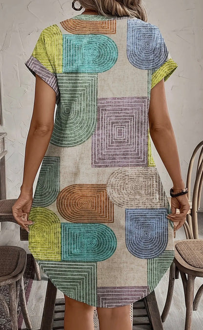 Abstract print button-front dress from Ivy's Gifts & Boutique, featuring a stylish A130 design with vibrant colors and a fitted silhouette.
