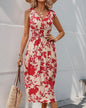 Red floral midi dress with elastic waist by Ivy's Gifts & Boutique, featuring a fitted bodice and flowing skirt.