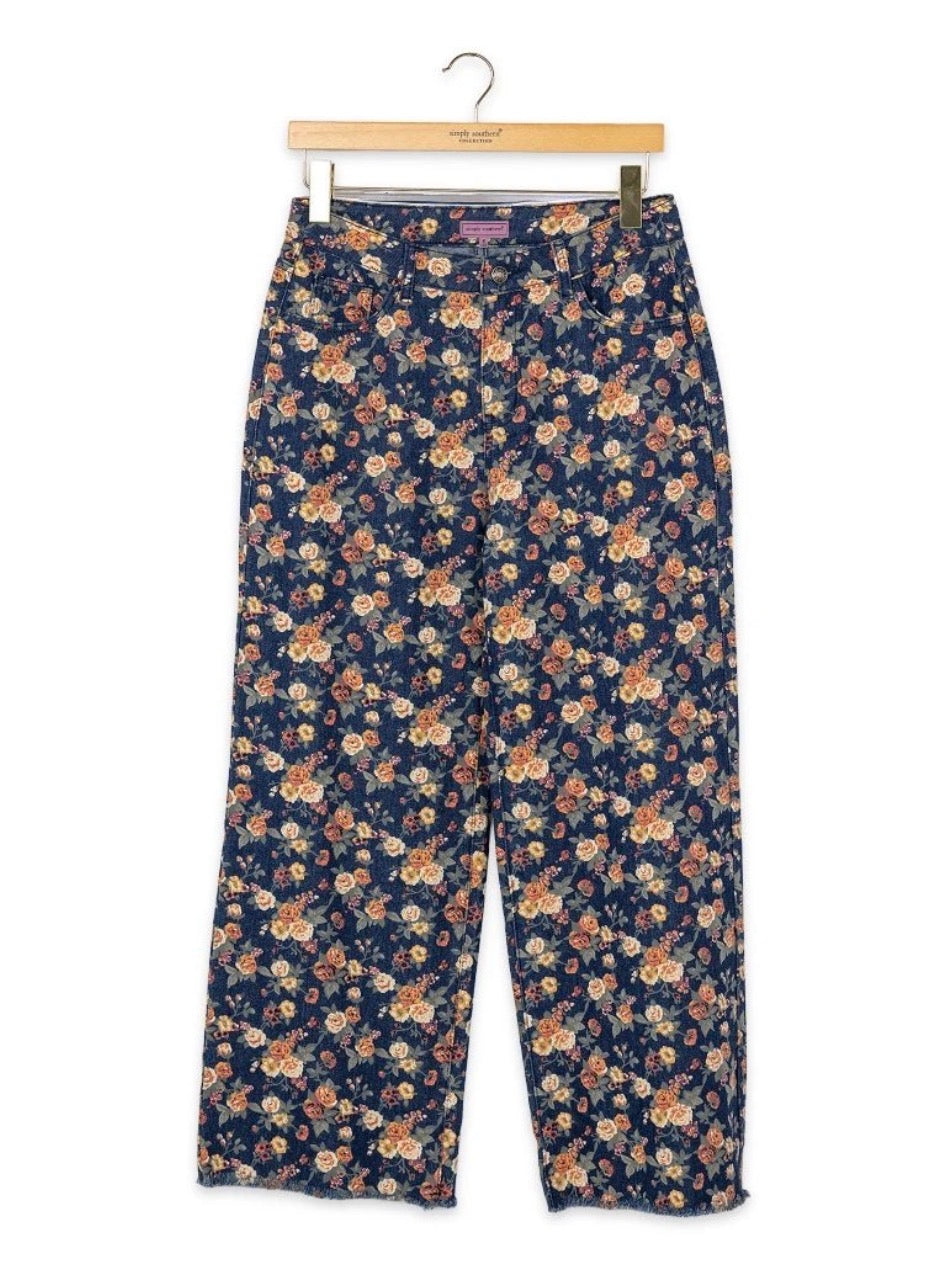 Floral stretch denim raw edge hem pants by Ivy's Gifts & Boutique featuring a relaxed fit and stylish floral print.