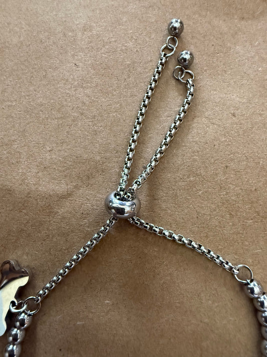 Silver dog bone charm bracelet with adjustable slide closure, featuring Ivy's Gifts & Boutique branding.