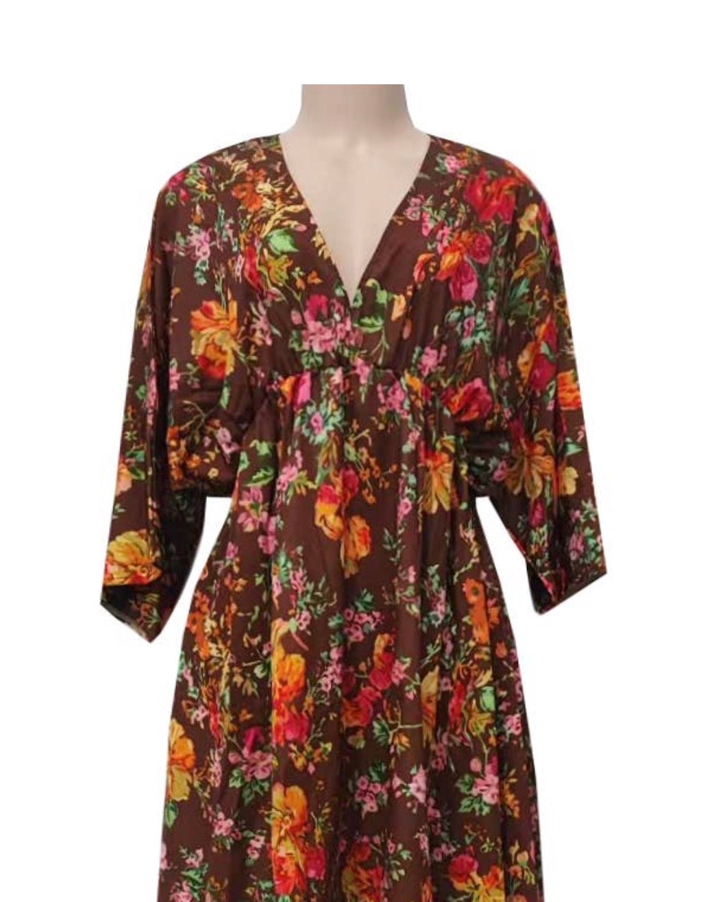 Gorgeous fall floral print dress with 3/4 length sleeves from Ivy's Gifts & Boutique, shown on a hanger with autumn-themed background.