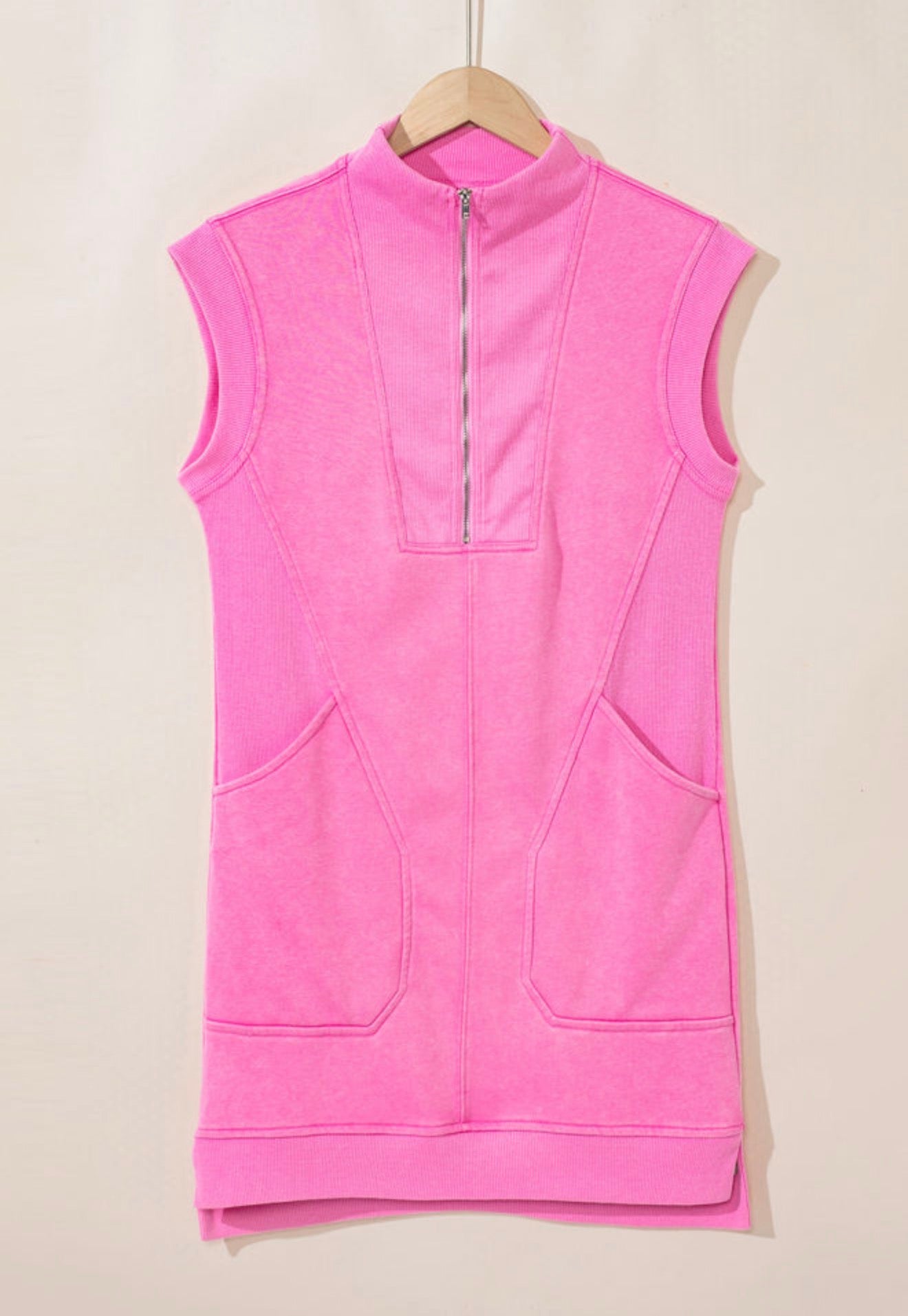 Bubblegum pink casual dress with zippered neckline and side split hem, by Ivy's Gifts & Boutique, shown on a hanger.