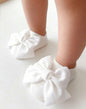 Baby's gray infant gripper sock from Ivy's Gifts & Boutique with a cute toe bow embellishment and non-slip soles.