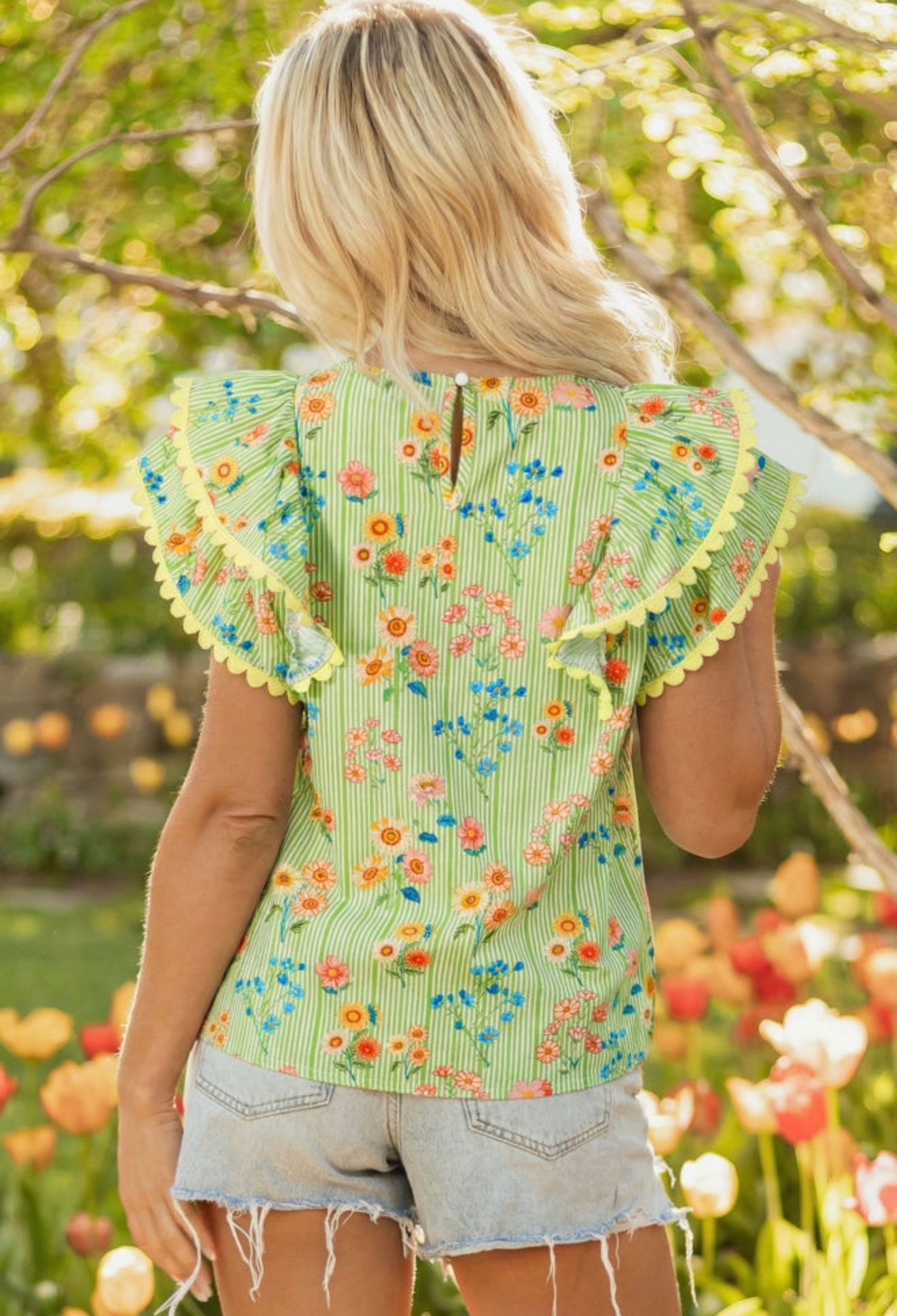 Green summer floral print top with ruffled cap sleeves and ric rac trim by Ivy's Gifts & Boutique