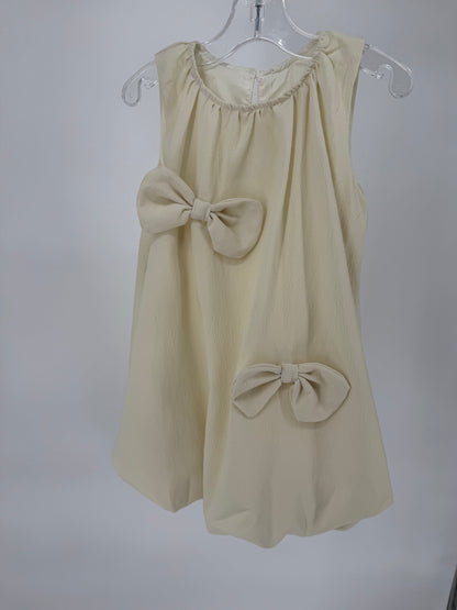 Ivory Bubble Hem Dress with Bow Accents by Ivy's Gifts & Boutique, featuring a stylish and feminine design.