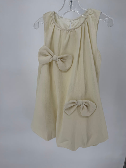 Ivory Bubble Hem Dress with Bow Accents by Ivy's Gifts & Boutique, featuring a stylish and feminine design.
