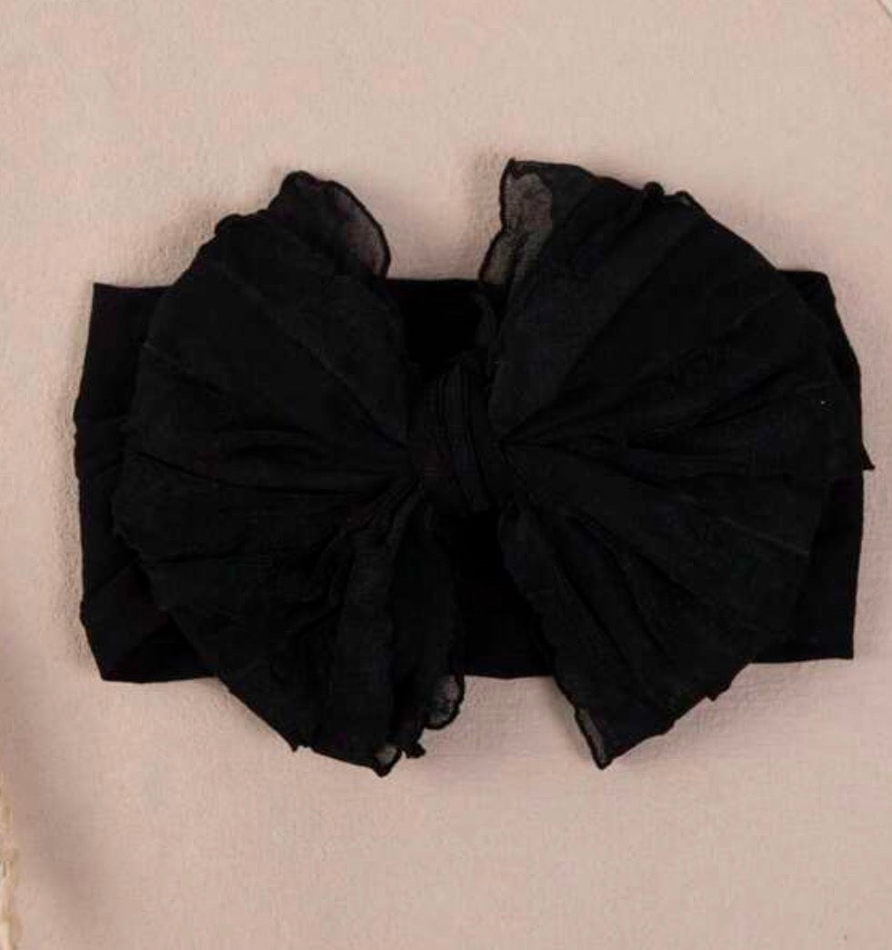 Infant headband with bow from Ivy's Gifts & Boutique, soft and comfortable accessory for babies' outfits.