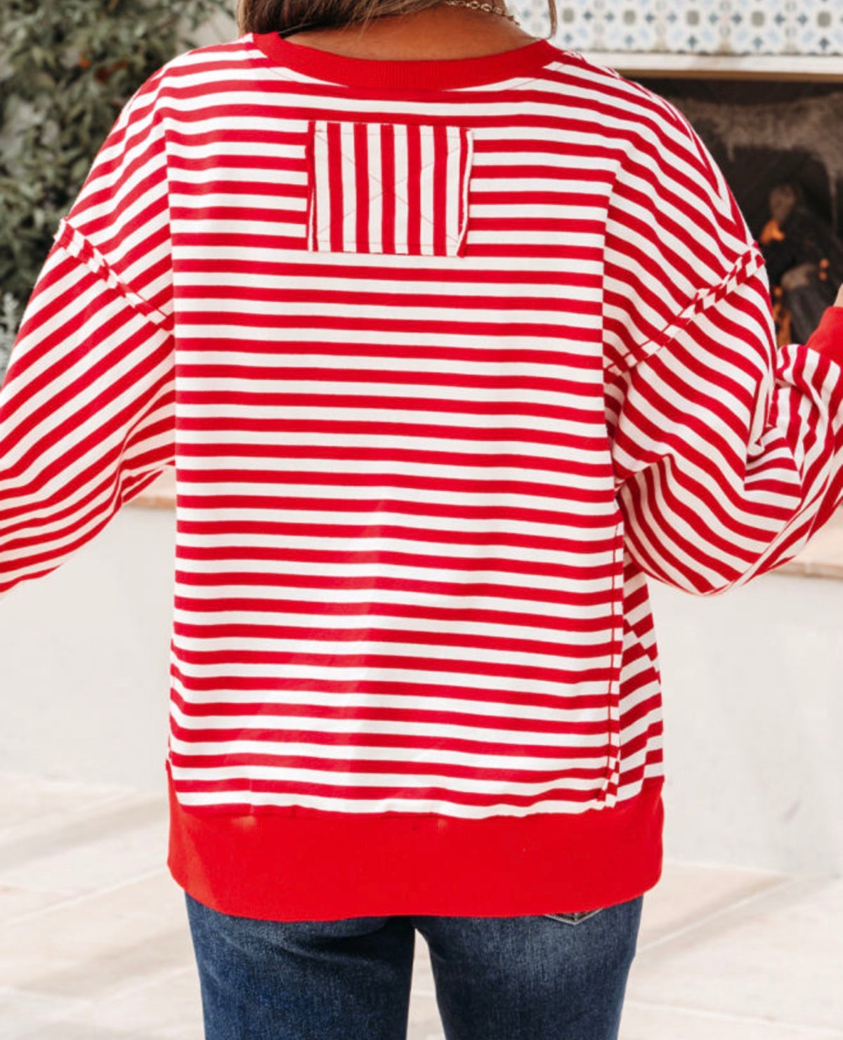 Ivy's Gifts & Boutique MLRS red and white striped long sleeve top with raw seam edges and square patch on the back.