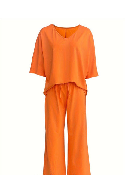 Orange bat wing style 2-piece set by Ivy's Gifts & Boutique, featuring a flowing fabric design with bat wing sleeves.