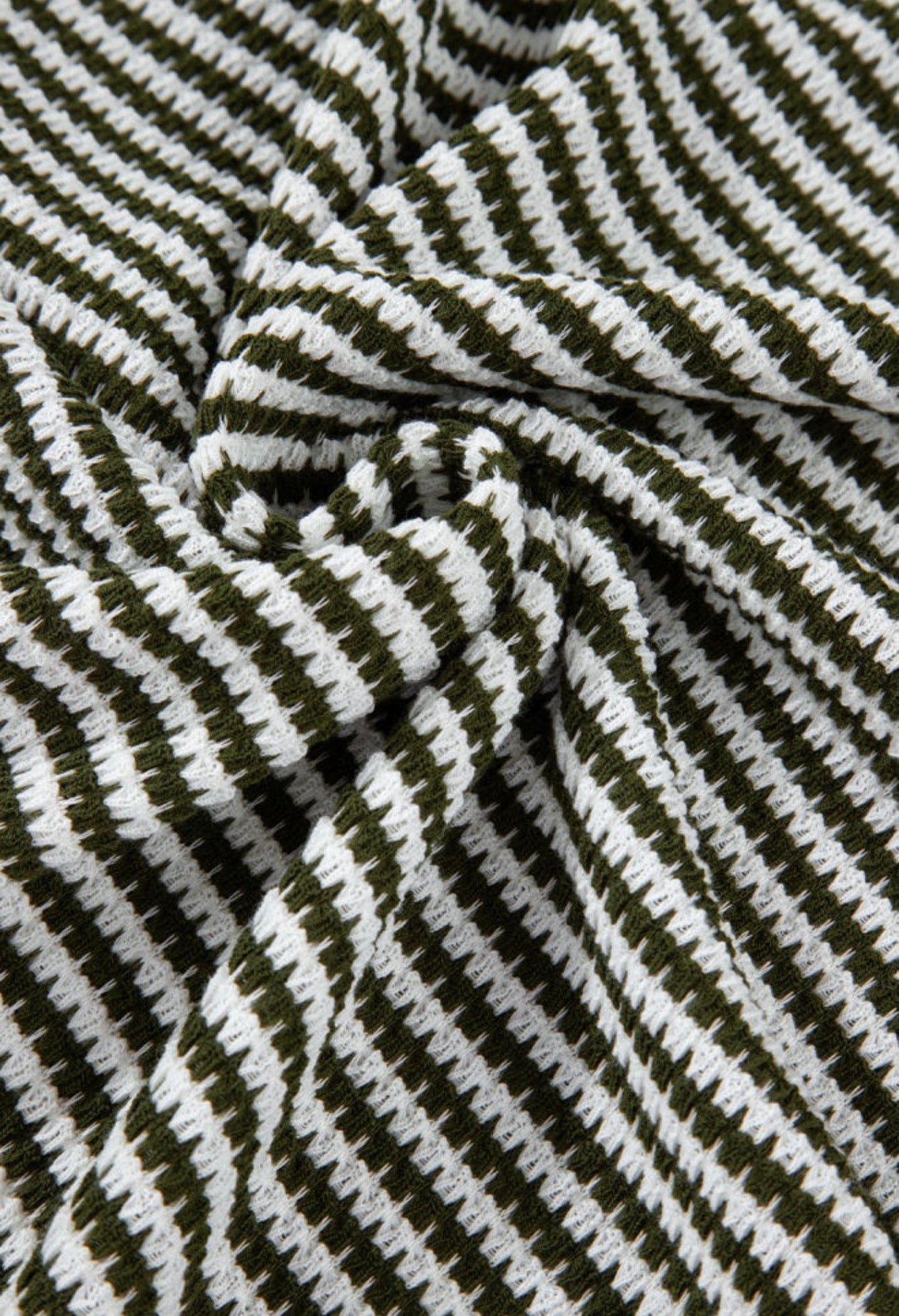 Green and white striped textured notched V-neck short sleeve top by Ivy's Gifts & Boutique, shown on a mannequin.
