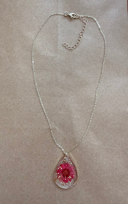 Dried flower pendant necklace with a silver chain from Ivy's Gifts & Boutique, showcasing a delicate floral design.