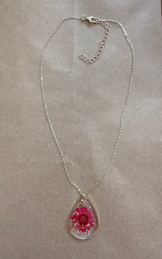 Dried flower pendant necklace with a silver chain from Ivy's Gifts & Boutique, showcasing a delicate floral design.