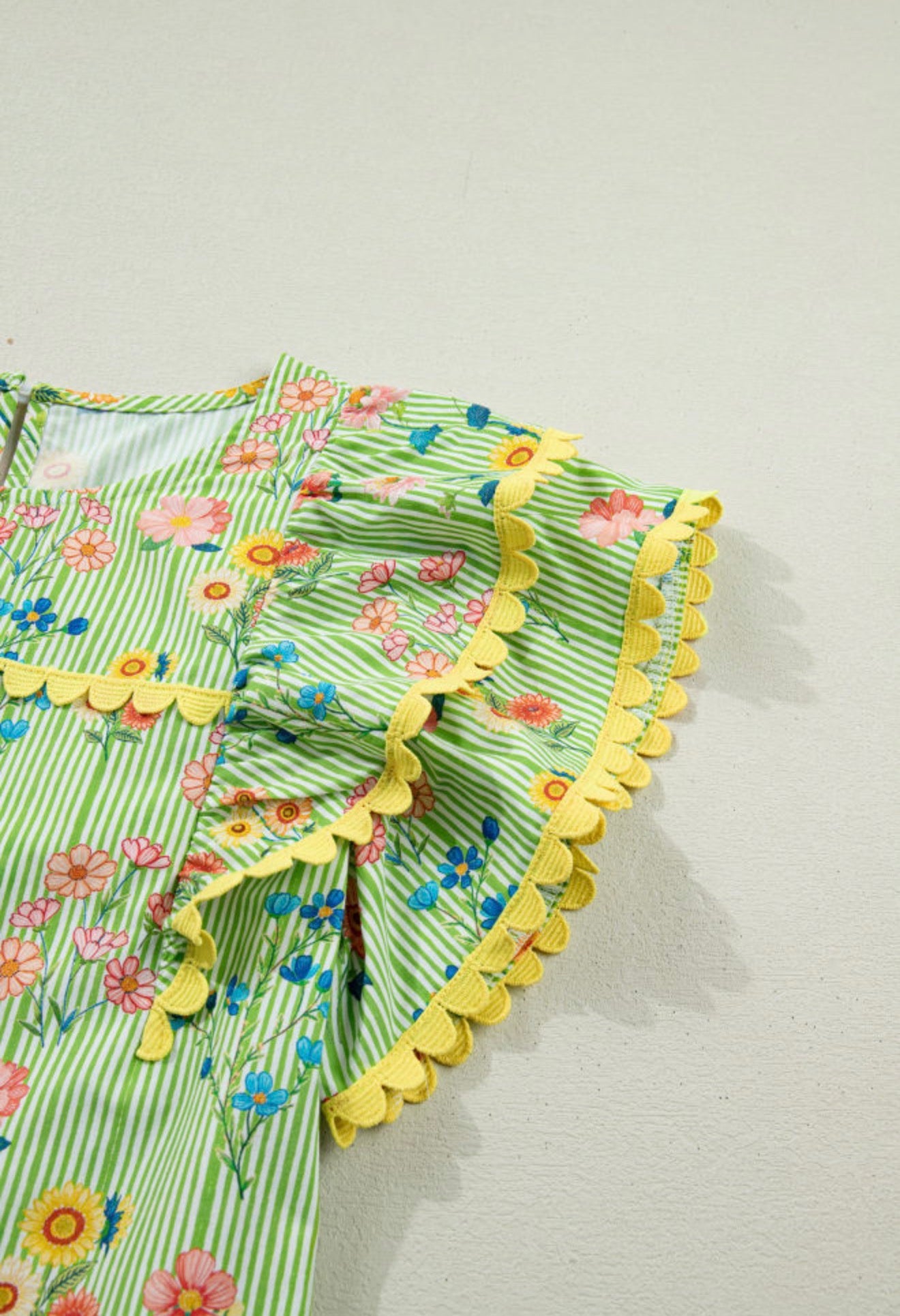 Green floral print summer top with ruffled cap sleeves and ric rac trim, by Ivy's Gifts & Boutique
