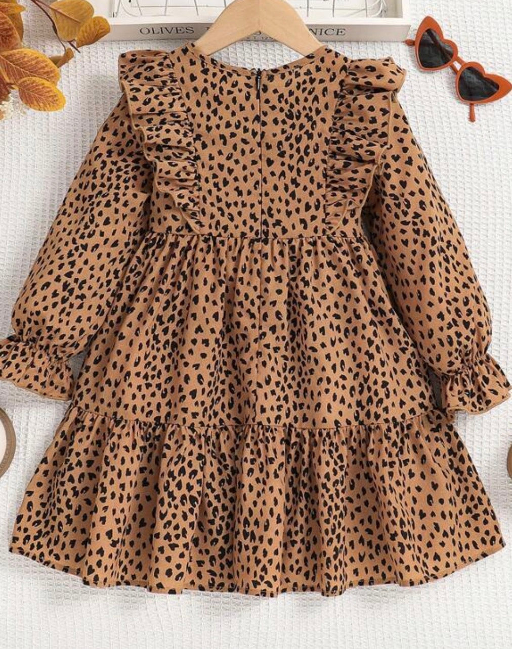Animal print long sleeve dress by Ivy's Gifts & Boutique featuring ruffle details on shoulders and hem, stylish and comfortable.