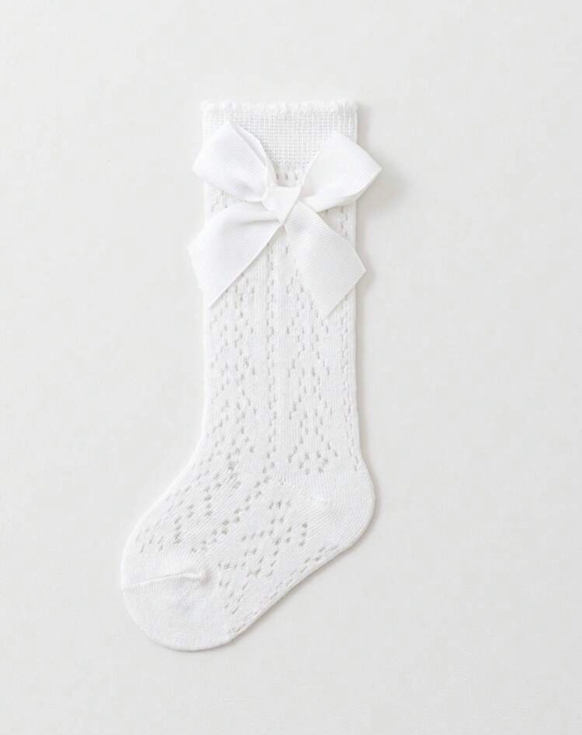 Baby knee socks with bow detail from Ivy's Gifts & Boutique, featuring soft fabric and adorable bow accents for infants.