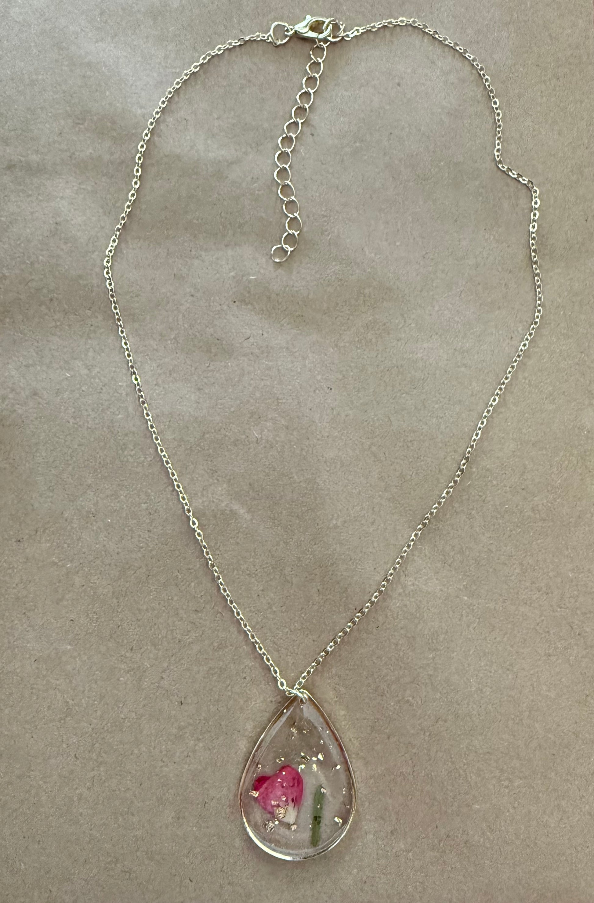Dried flower pendant necklace from Ivy's Gifts & Boutique featuring a delicate floral design on a silver chain.