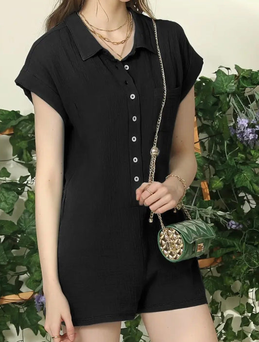 Black romper by Ivy's Gifts & Boutique featuring short sleeves, button front, and wide short legs, shown on a hanger.